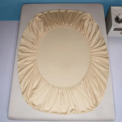 Beige satin toilet seat cover with elasticized edge complementing decorbites 1000tc egyptian cotton fitted sheet set