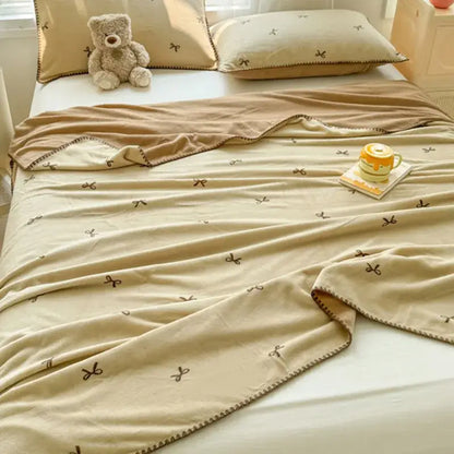 Beige scalloped cozy coral fleece blanket with small brown bow patterns and stitched border for bedroom decorbites cozy coral fleece