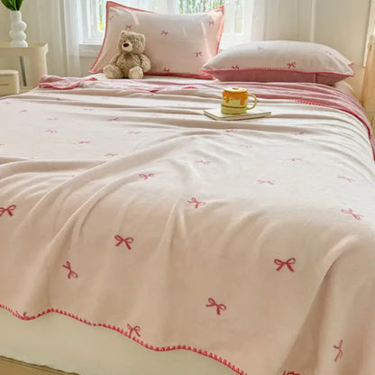 Beige scalloped cozy coral fleece blanket with soft pink fabric and delicate red bow embroidery for decorbites cozy coral decor