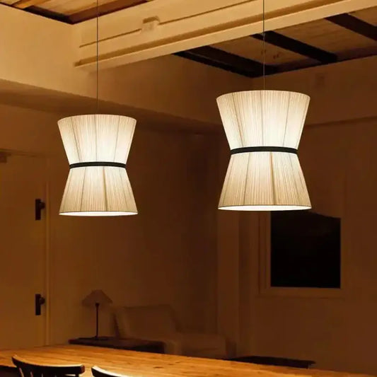 Two beige tapered pendant lamps with black bands in decorbites cocoon cloth chandelier for kitchen lighting