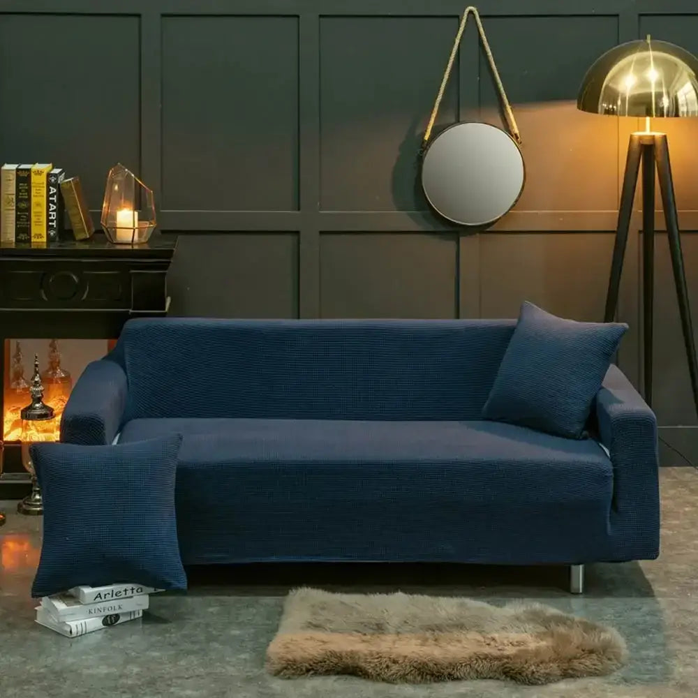 Navy blue textured fabric sofa cover with matching throw pillows showcasing decorbites 3d quilted sofa cover design