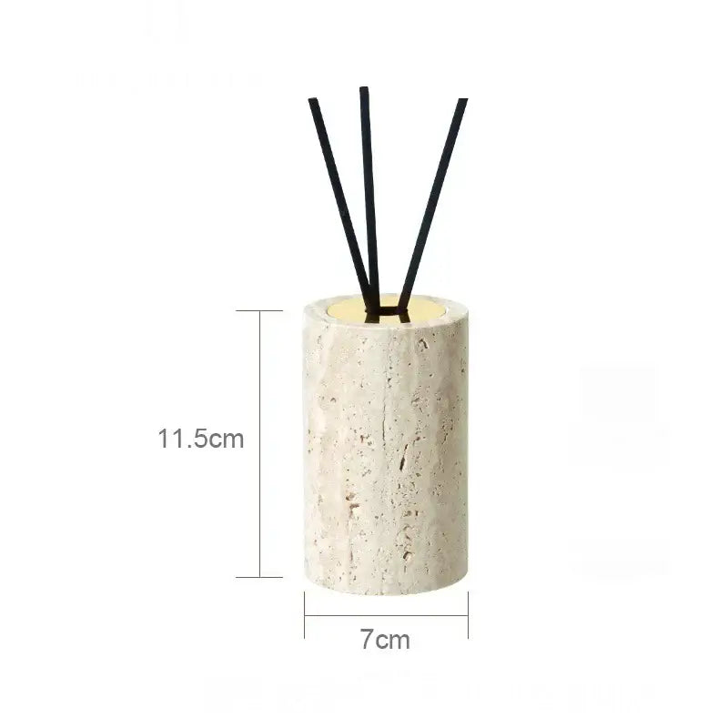 A beige travertine marble cylindrical stone diffuser with textured surface and four black reed sticks for decorbites beige travertine set