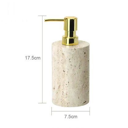 A cylindrical beige travertine marble soap dispenser with a polished gold-tone pump from decorbites beige travertine set