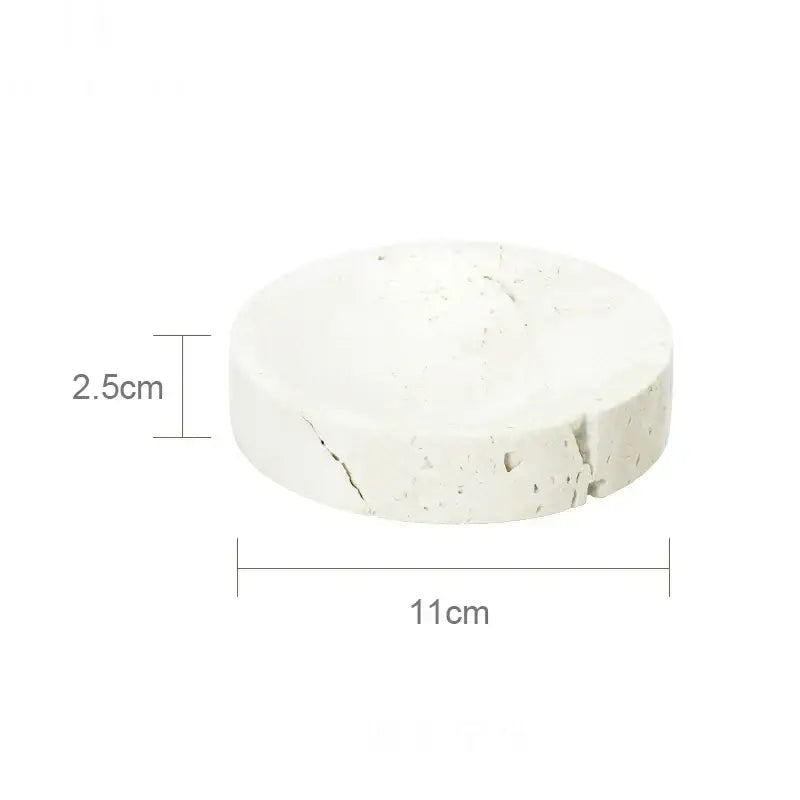 Beige travertine marble bathroom set featuring a white textured concrete coaster with subtle cracks and rough surface