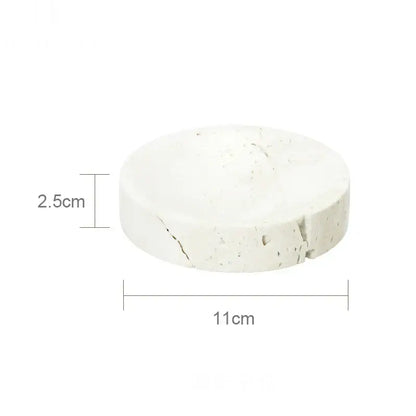 Beige travertine marble bathroom set featuring a white textured concrete coaster with subtle cracks and rough surface