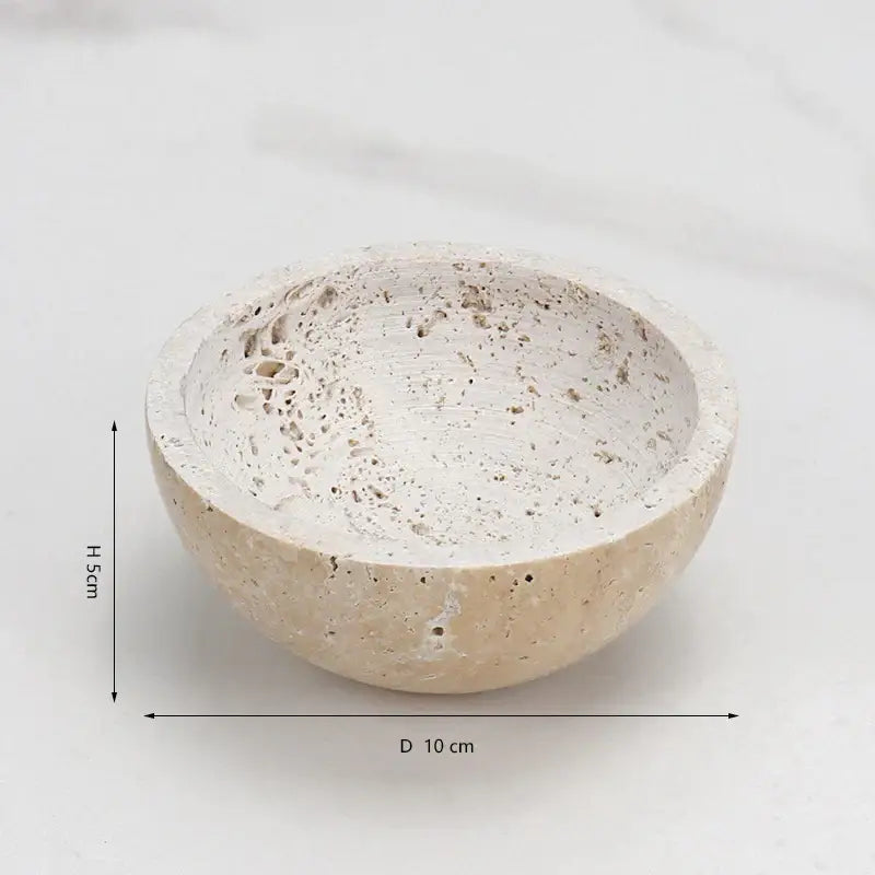 A beige travertine marble sphere incense burner with speckled porous texture for living room decor by decorbites