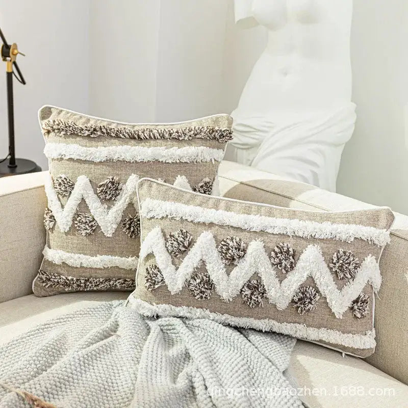 Beige rectangular cushion cover with diamond tufted zigzag embroidery white and brown fringe and pom-pom accents