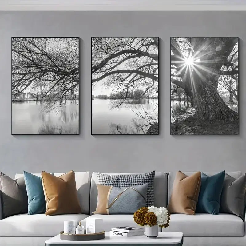 Three black and white framed canvas prints of tree lake sunset branches over water on a gray wall by decorbites