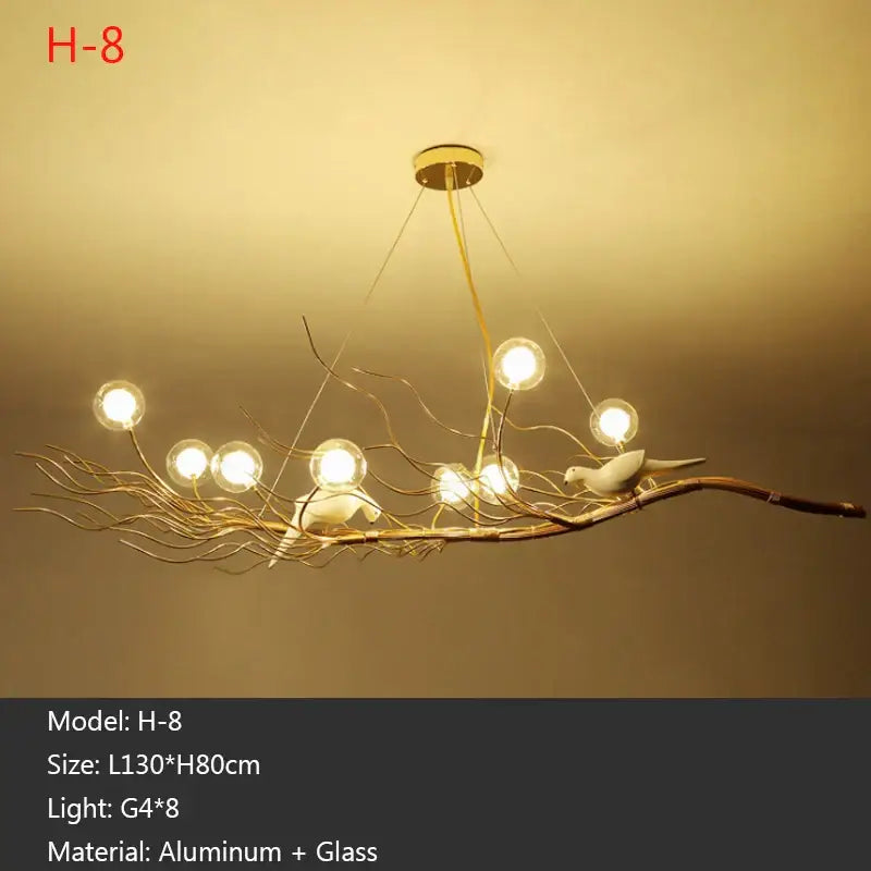 Gold-toned h-8 nest led pendant light with branching aluminum arms glass globe lights and white ceramic birds for dining room decor