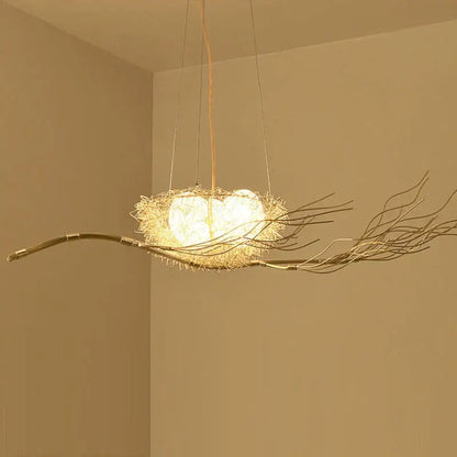 A warm-toned rustic bird nest led pendant light crafted from woven twigs and wire for dining room and cafe decor