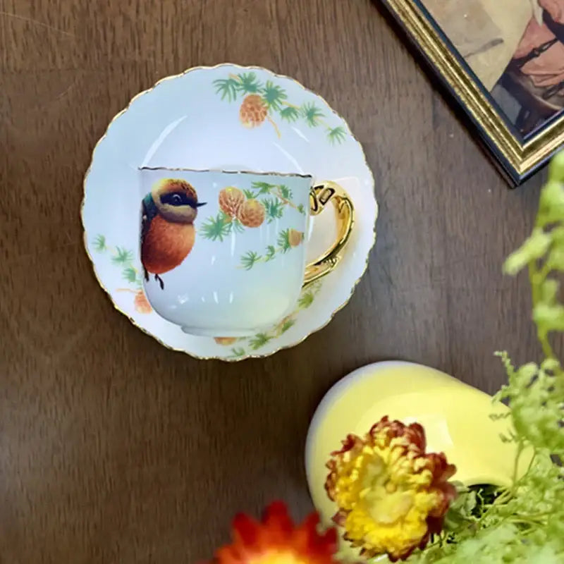 A delicate white porcelain bird pattern ceramic gold trimmed mug and saucer set for dining room decorbites bird pattern