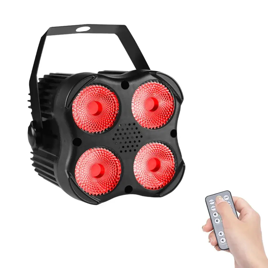 Black 4x8w mini rgbw led stage par light with four red bulbs and carrying handle shown with remote control for dj events