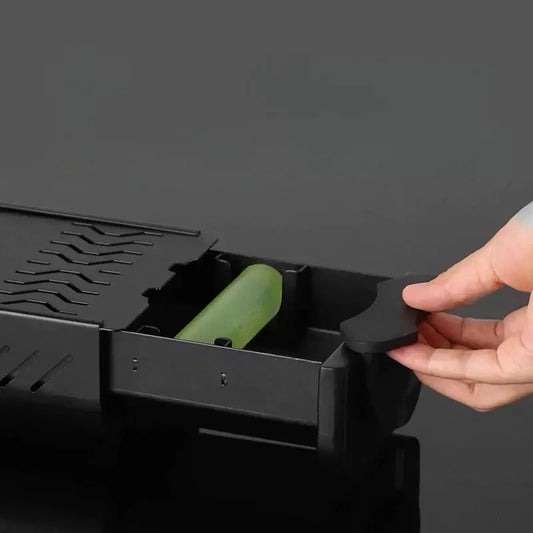 Black plastic barista tamping station tray with green cylindrical item for kitchen organizers and knockbox grounds bin use