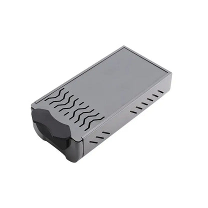 Gray rectangular knockbox grounds bin with black curved handle and wavy cutouts for barista tamping station tray