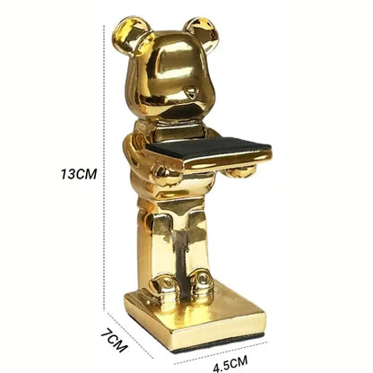 Golden cartoon bear watch stand holding a black tray for bedroom decor with black and iridescent purple accents