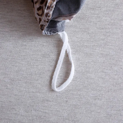 White braided drawstring loop on the back side of black and rose gold leopard print duvet set decorbites leopard print