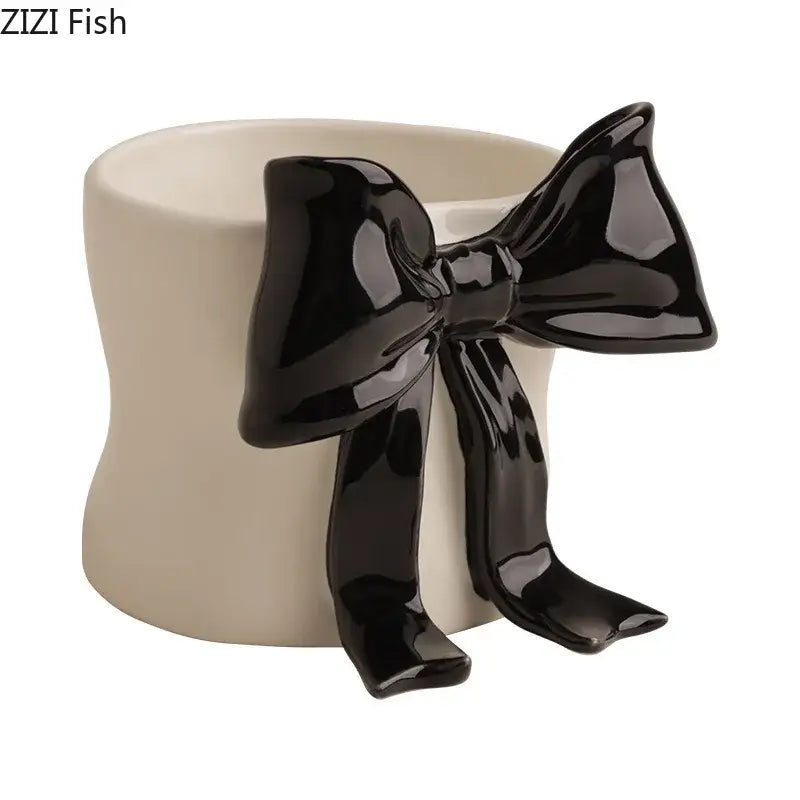 Cream-colored porcelain coffee cup with glossy black bowknot accent for dining room use