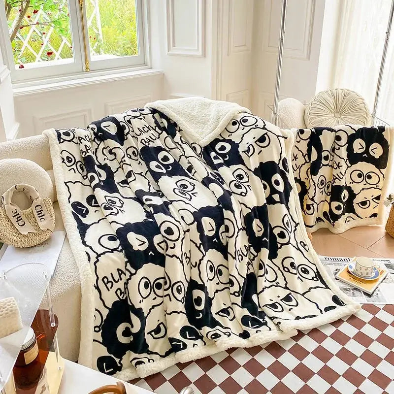 Cream-colored cozy blanket with black and white cartoon print panda pattern and soft sherpa lining by decorbites cartoon print