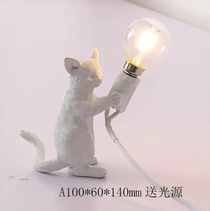 White ceramic cat resin table lamp holding a lit bulb designed as ornamental bedroom decorbites cat resin piece