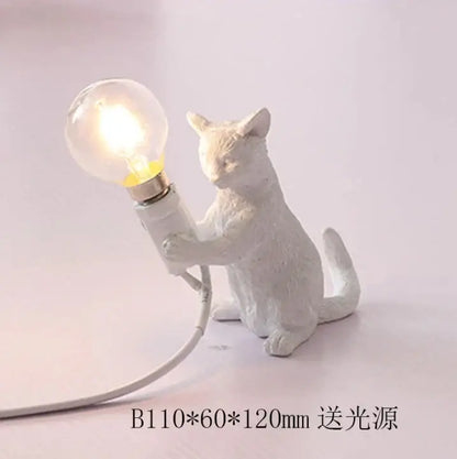 White ceramic cat resin table lamp holding a glowing bulb for bedroom decorbites cat resin decorbites cat resin table