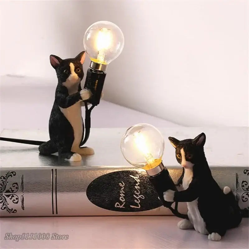 Black and white cat resin table lamp featuring a cat figurine holding a glowing bulb for bedroom decorbites decor