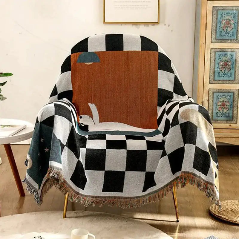 Black and white fox cozy plaid wool blend blanket with dog illustration and fringed edges under orange lampshade decorbites cozy plaid