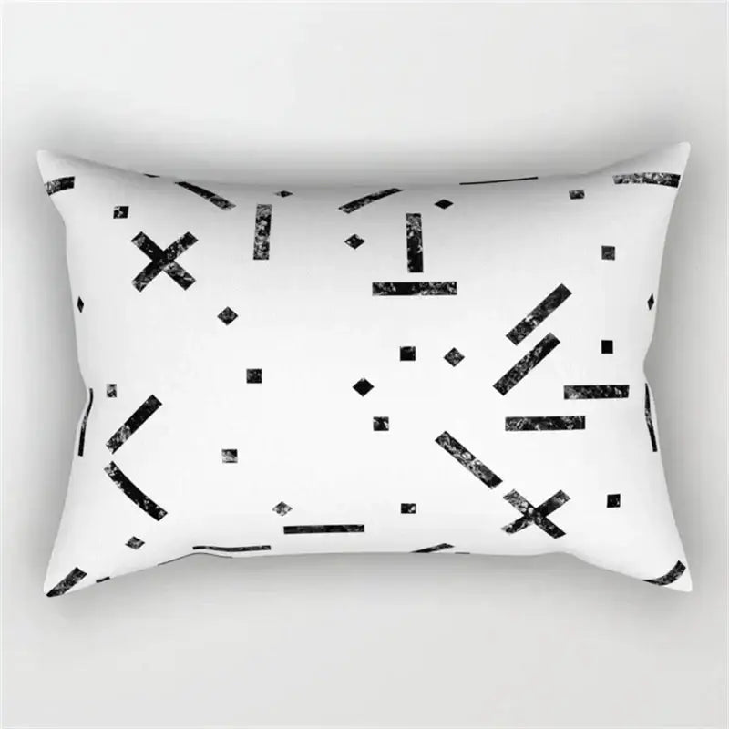 White rectangular pillow with black geometric wave line pattern featuring distressed lines crosses and dots for bedroom decor