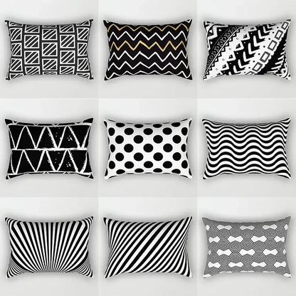 Nine black and white rectangular throw pillows with geometric wave line patterns arranged in a grid for bedroom decor