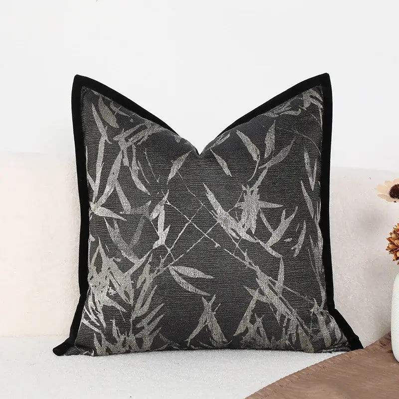 Black pillow cover with silver bamboo leaf pattern and velvet trim for green jungle plants themed living room decor