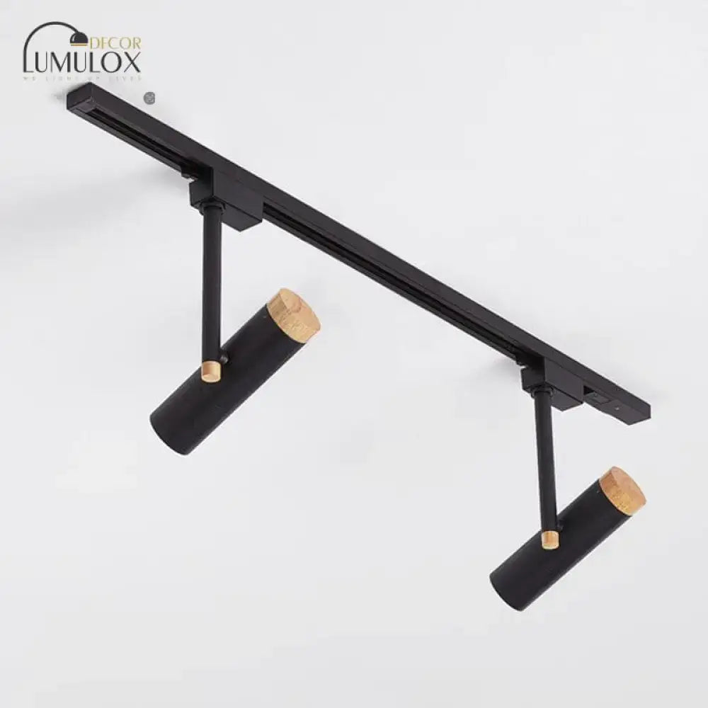 Black cylindrical track lights with wooden caps mounted on a sleek black rail by decorbites™ nordic spotlight