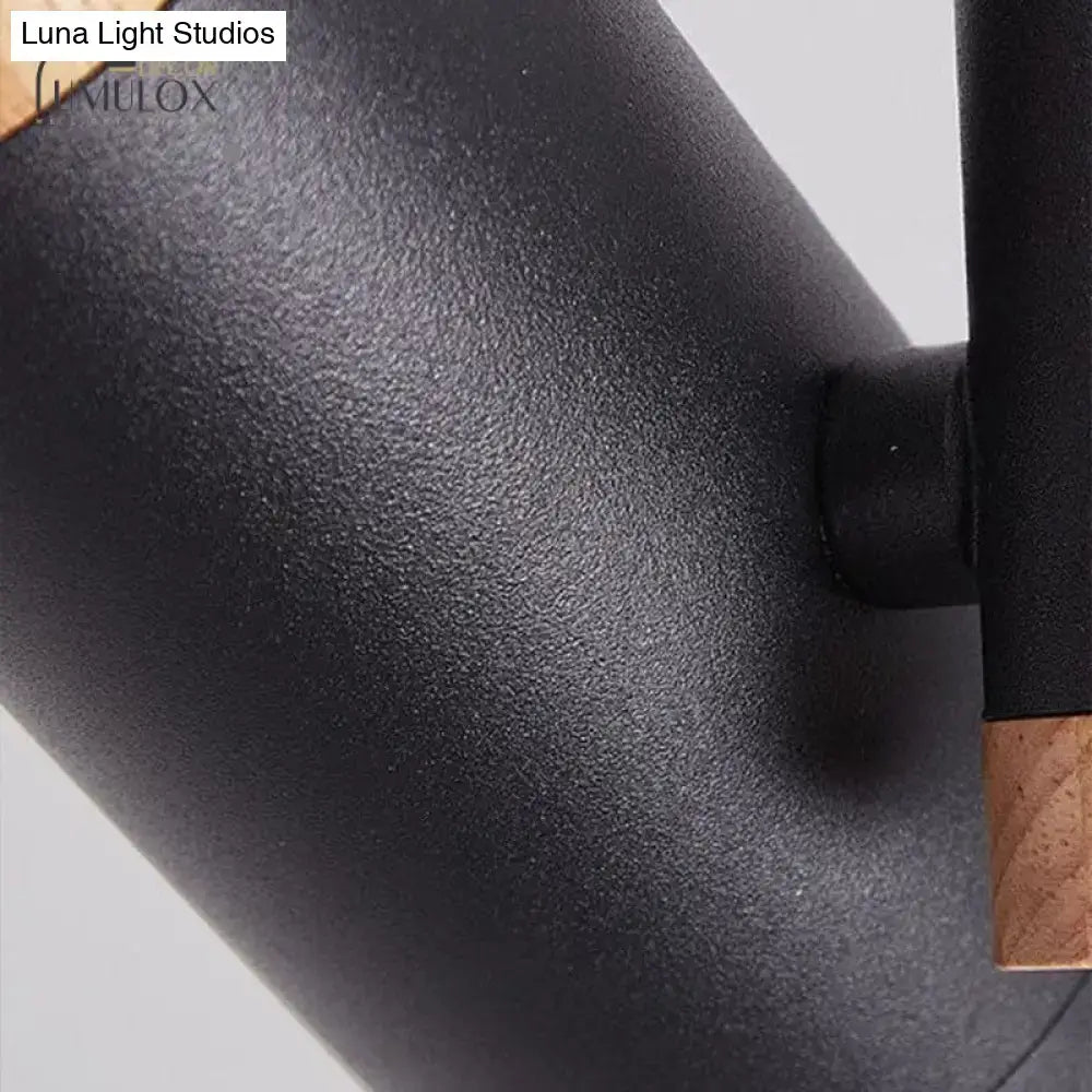 Black matte metal spotlight with wooden accent at the joint from DecorBites™ Nordic tubular metallic collection