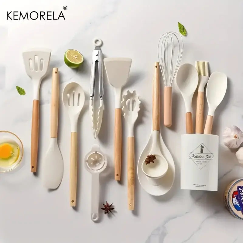 Kemorela silicone kitchen utensil set with white silicone heads, light wood handles, and ceramic spoon rest in kitchen box