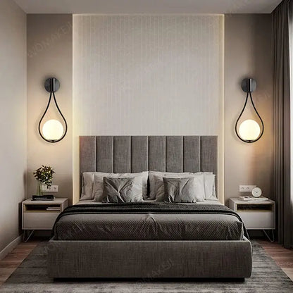 Gray upholstered bed shown alongside decorbites™ black battery operated wall sconces with remote and usb type-c charging
