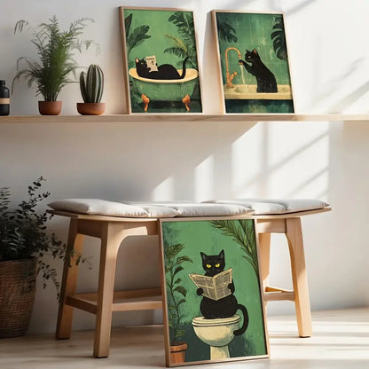 Three framed wall art prints of black cat bathroom scenes with green backgrounds by DecorBites™