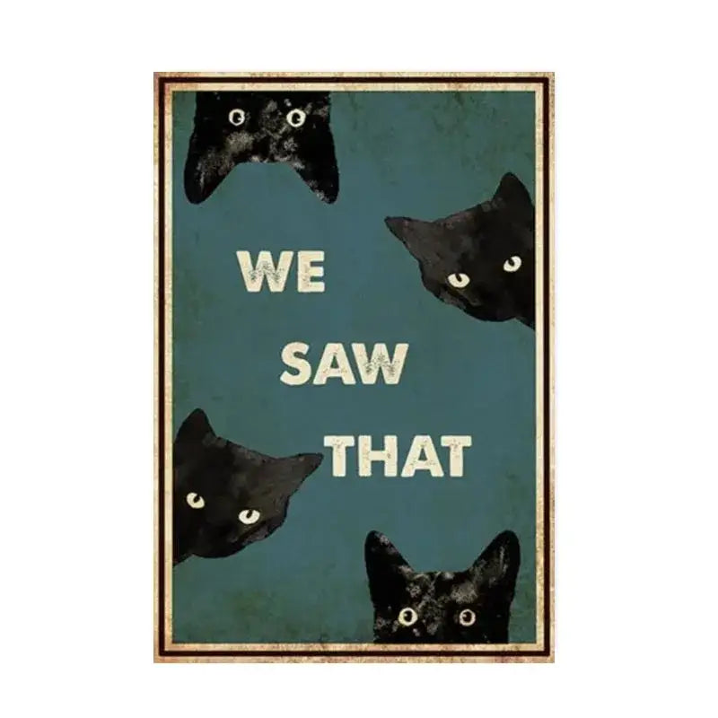 A framed teal DecorBites black cat reading poster with four black cat faces and cream we saw that text for home decor