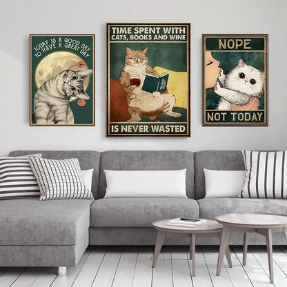 Three framed cat-themed posters including decorbites™ black cat reading music poster above gray sectional sofa