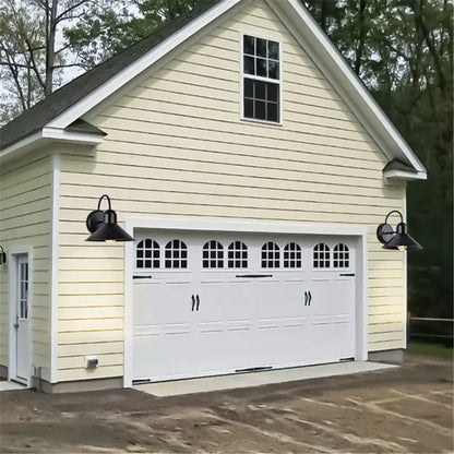 White garage door with arched window panels and black handles paired with decorbites black farmhouse barn lights outdoor gooseneck sconce