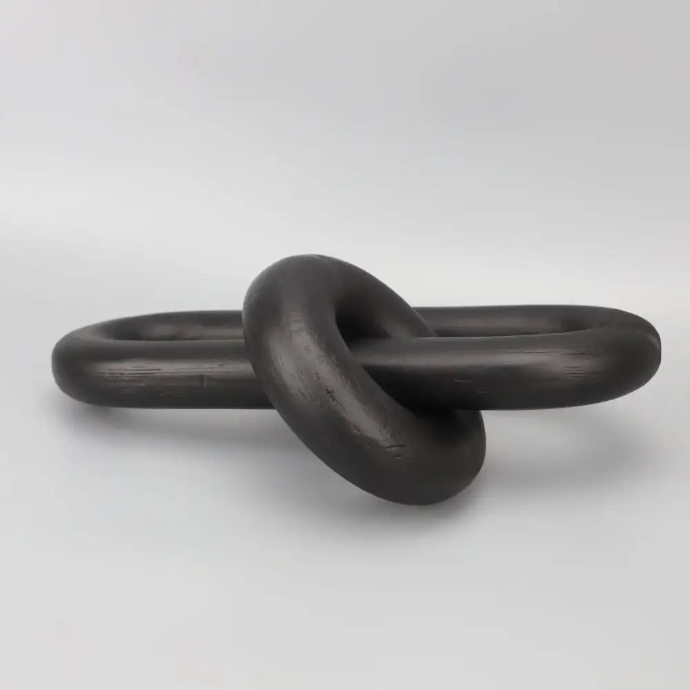 Black matte-finished ceramic knot sculpture as a decorbites black geometric resin ornament for living room decor