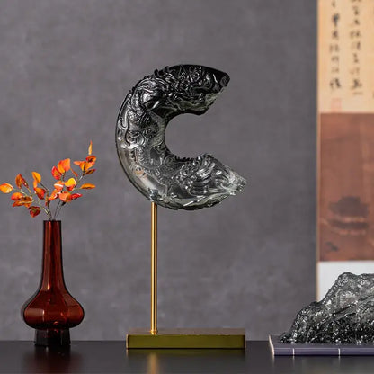 Black glass dragon sculpture with intricate carvings on a gold stand for decorbites crescent moon living room decor