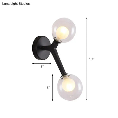 Black metal bubble wall sconce with two clear glass globe shades for bedroom lighting decor