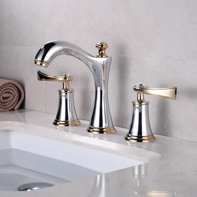 Black and gold crystal waterfall brass bathroom sink faucet with chrome and gold two-handle design and crystal accents
