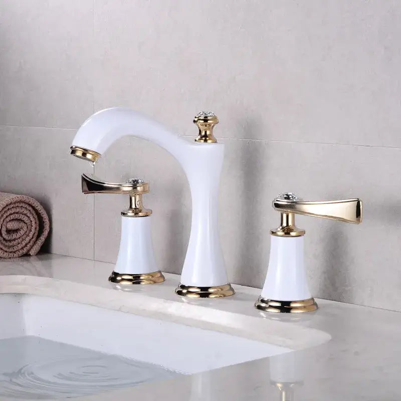 White ceramic bathroom sink faucet with gold brass accents and crystal knobs for elegant bathroom sink faucets design