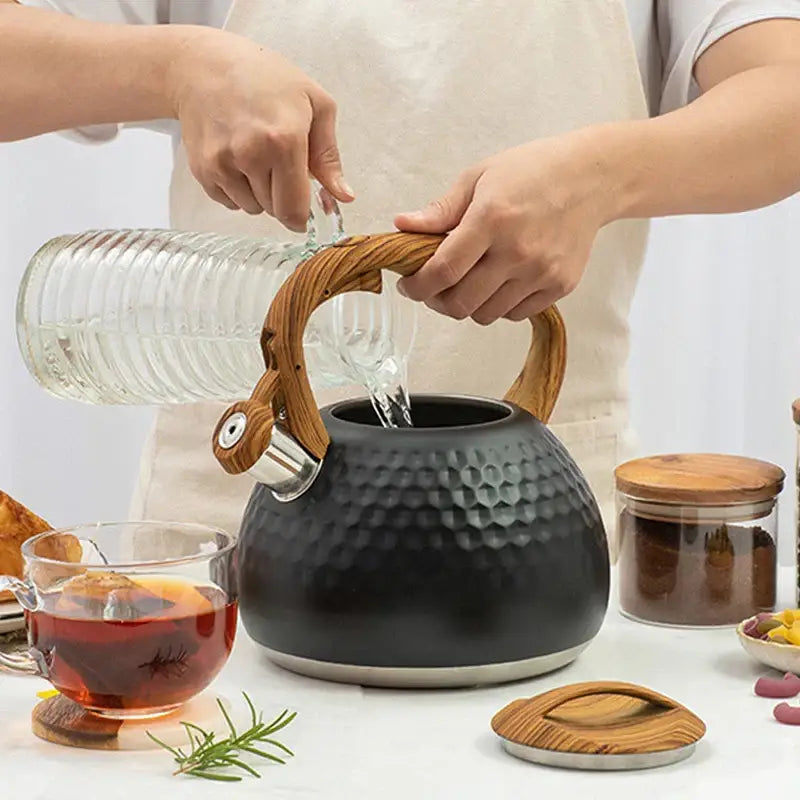 Black hammered stainless steel whistle boiling kettle with honeycomb ceramic body wooden handle and stainless steel spout