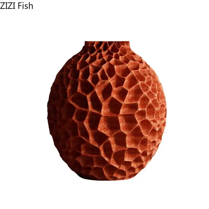 A terracotta ceramic vase with honeycomb texture ideal for artificial flower arrangement in living room decor