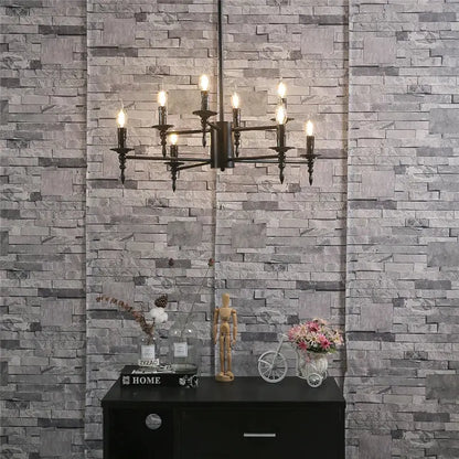 Black iron art candle chandelier pendant light featuring multiple lit candle-like bulbs for living room decorbites iron art