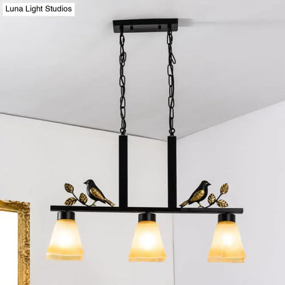 DecorBites black light pendant with gold bird and leaf accents and three warm tan glass shades for dining room island lighting