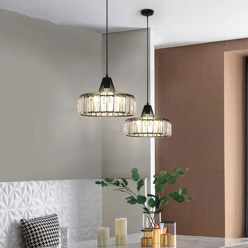 Two modern black metal crystal kitchen pendant lamps with clear prisms emitting warm glow for decorbites crystal kitchen decor