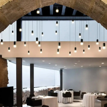 Black minimalist led wall lamp with modern black cylindrical pendant lights featuring warm white bulbs for bedroom decorbites