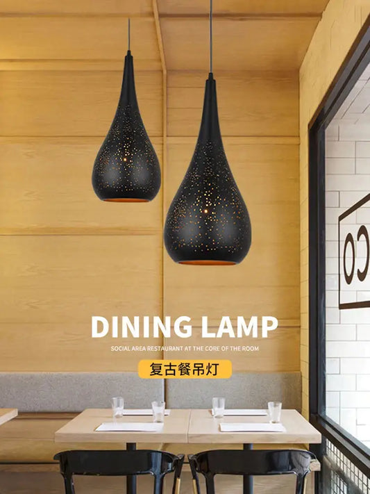 Black perforated iron hollow droplight pendant light with teardrop shape and warm interior lighting for dining room decorbites