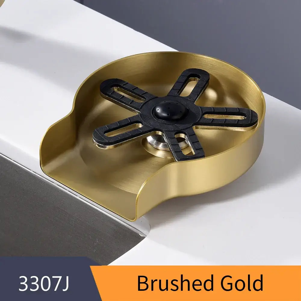 Brushed gold metal sink drain cover with black rubberized star-shaped center for home kitchen glass rinser and cup washer